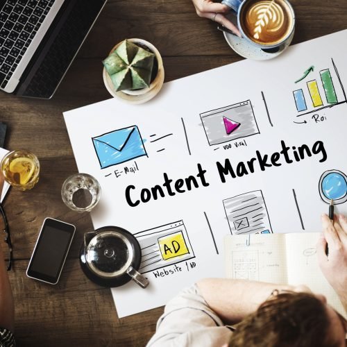 Online strategy and media marketing icons arranged around a laptop
